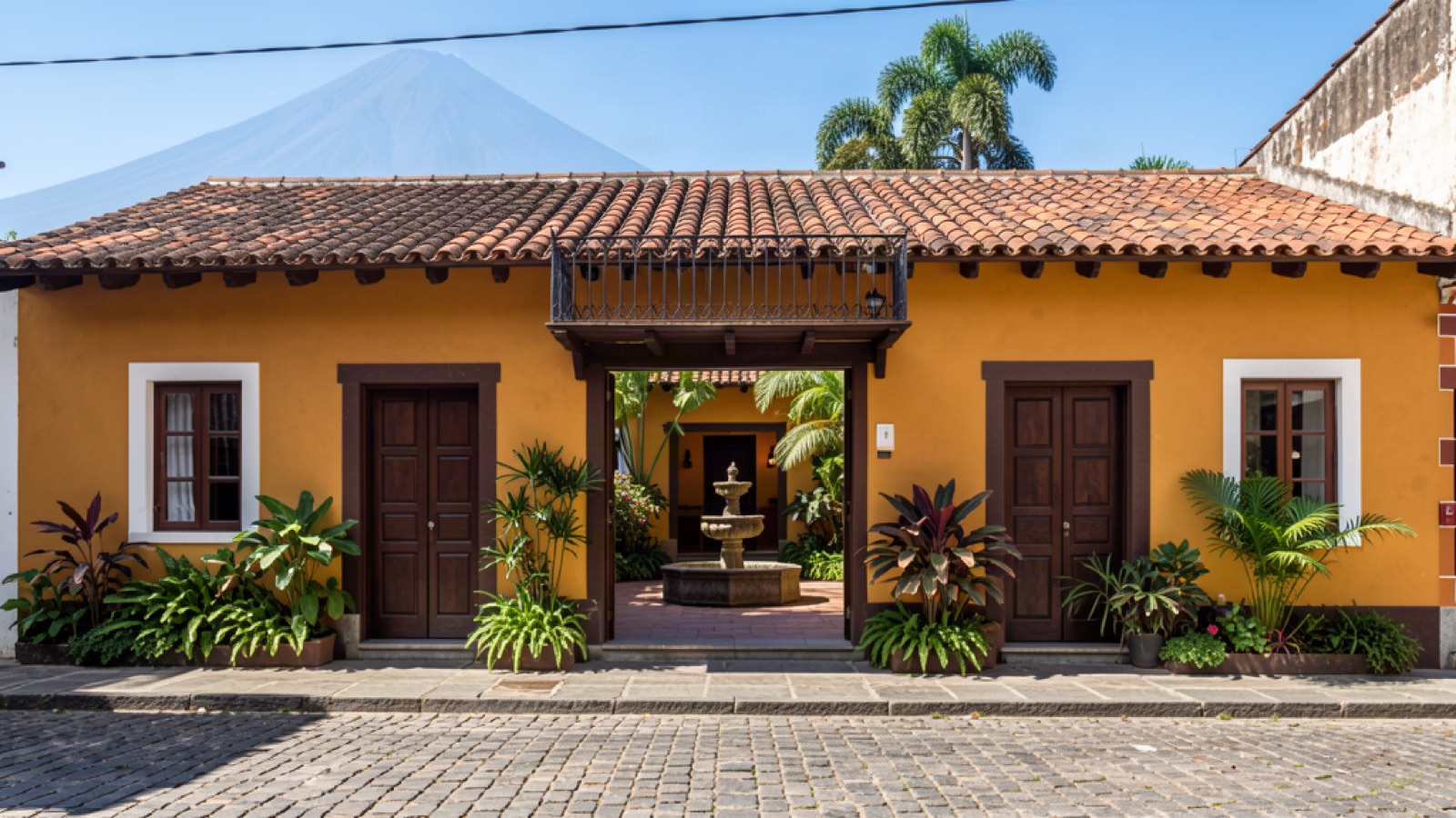Colonial courtyard home in Antigua Guatemala with stone fountain and tropical plants