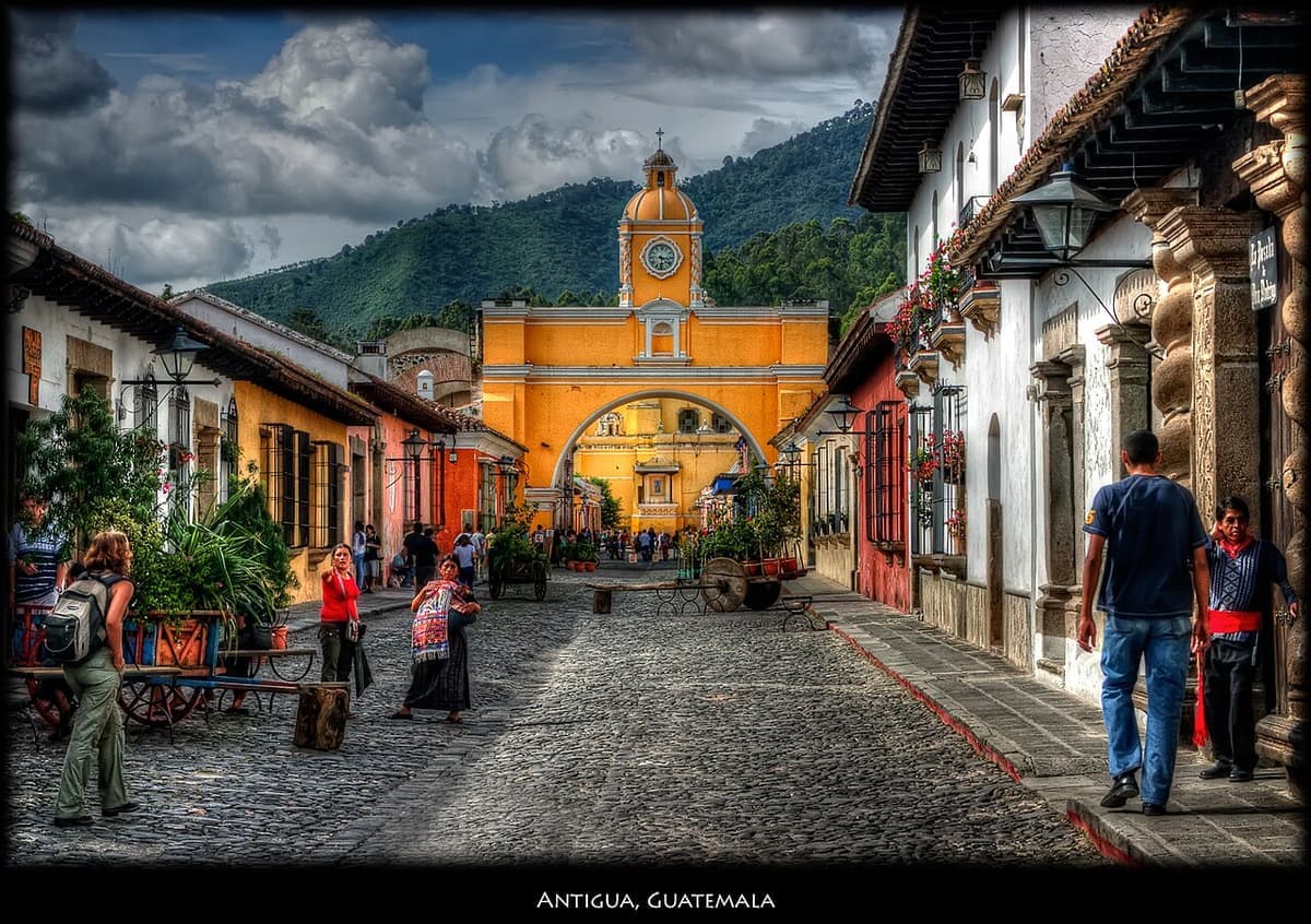 Aerial view of Antigua Guatemala with volcano backdrop and colonial rooftops
