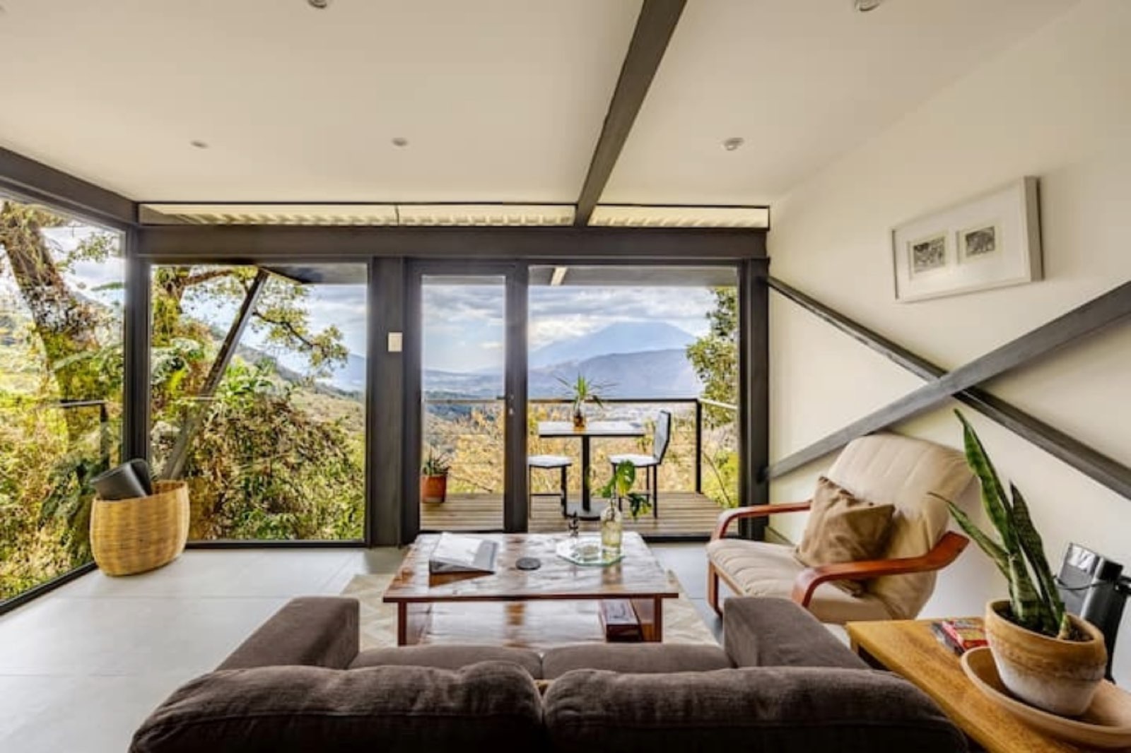 Spacious modern apartment with floor-to-ceiling windows, private terrace, and panoramic volcano views surrounded by forest at Finca El Tambor, El Hato, Antigua Guatemala